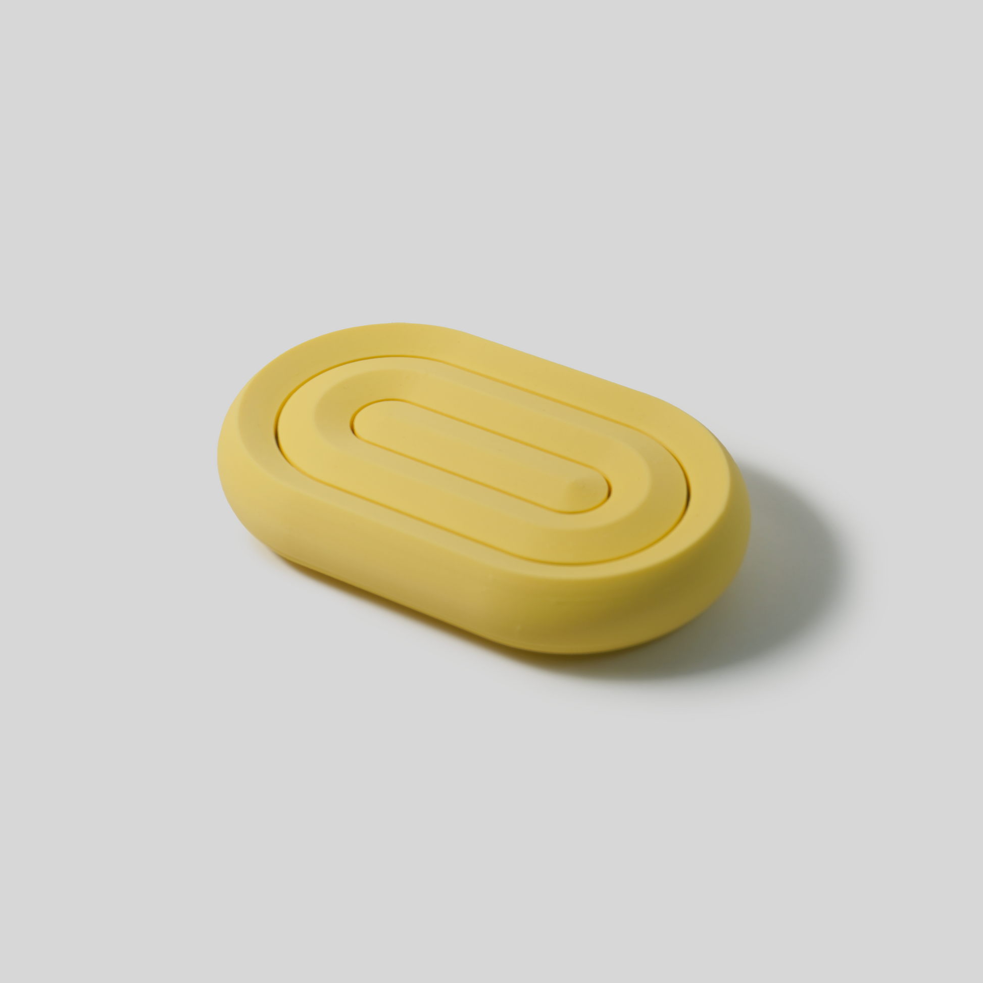 Yellow oval object on a light gray background