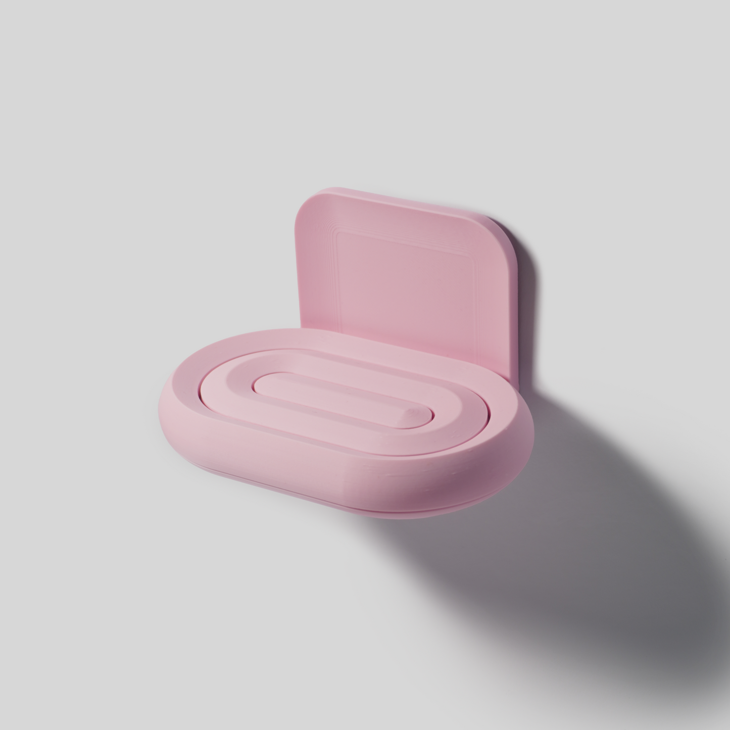 Pink soap holder on a light gray background