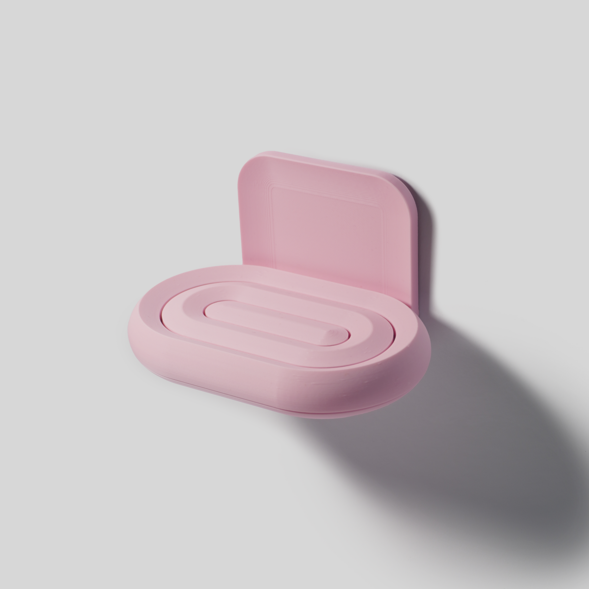 Pink soap holder on a light gray background