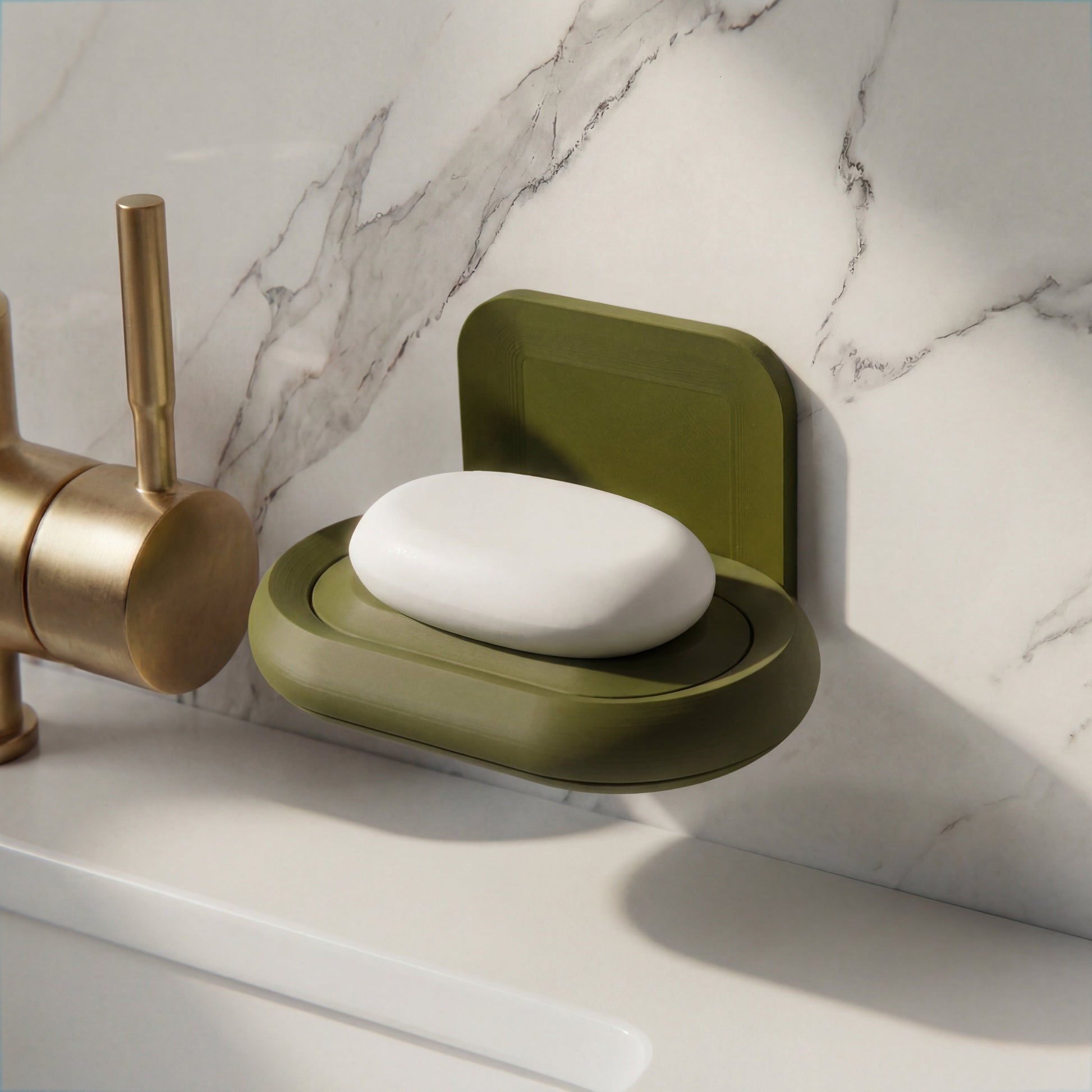 darl Green soap holder with a bar of soap over a marble bathroom counter.