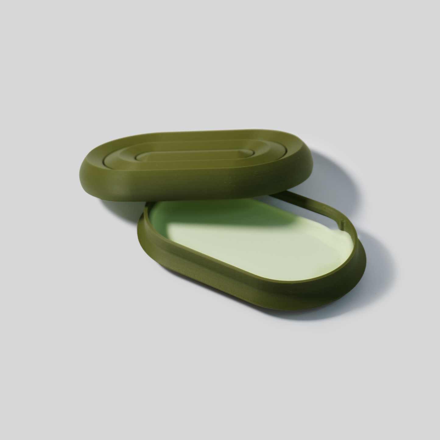 dark Green open soap holder on a light gray background