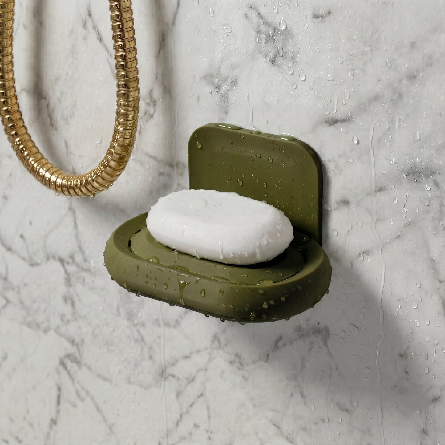 dark Green soap dish with a bar of soap on a marble shower wall
