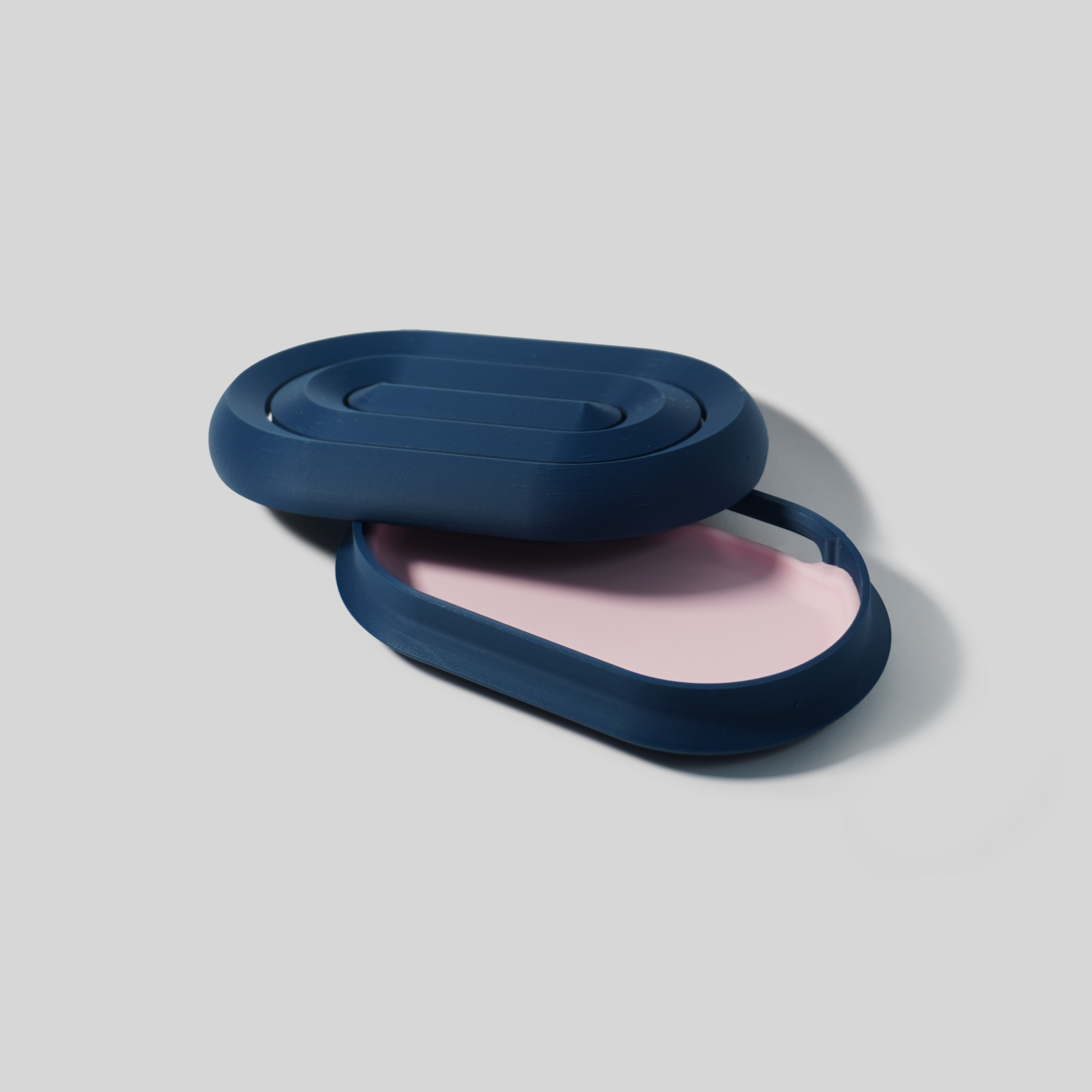 open Blue and pink soap holder on a light gray background