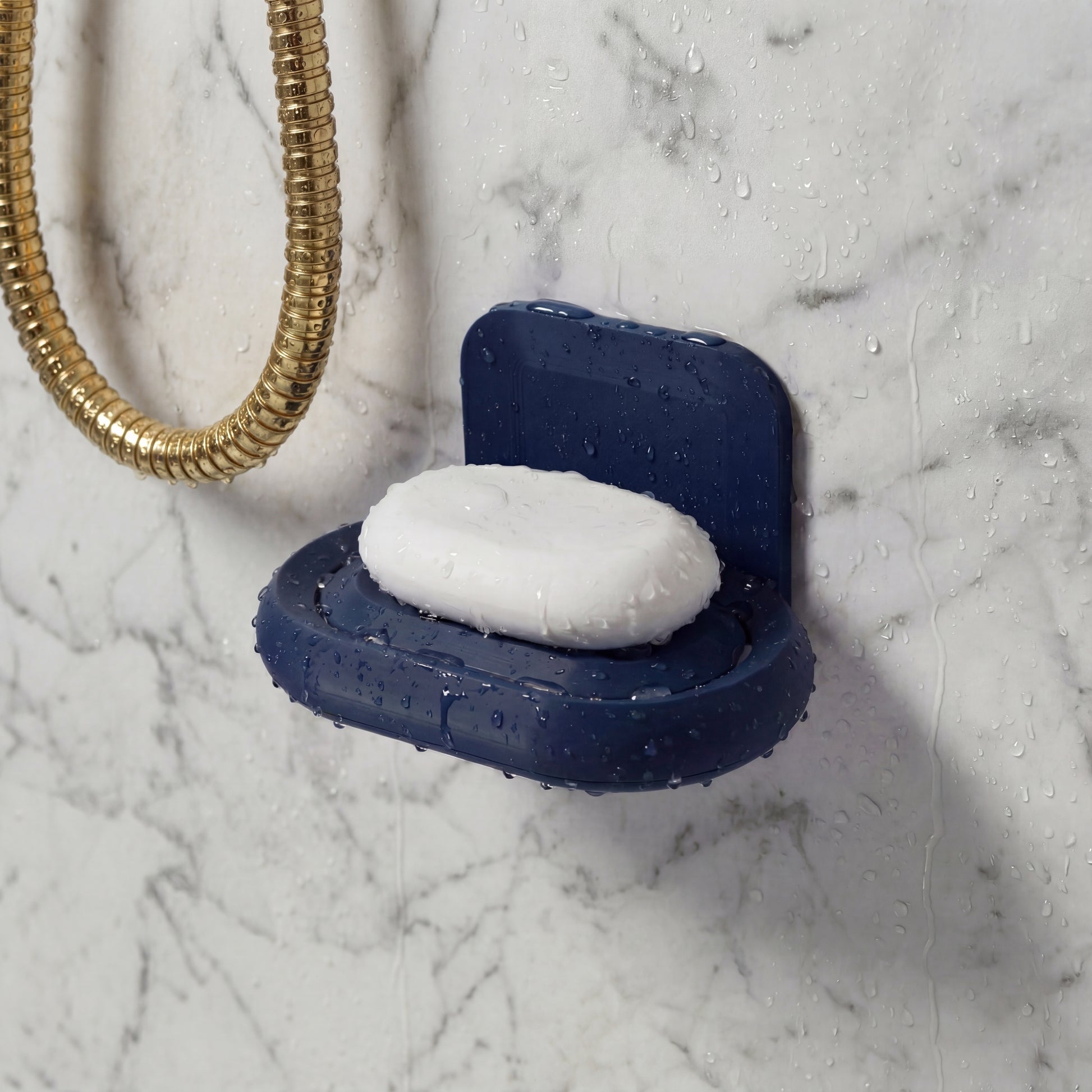 Blue soap dish with a bar of soap on a marble shower wall