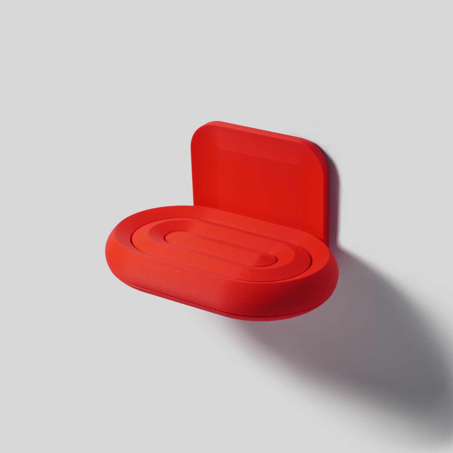 Red plant-based soap holder on a white background