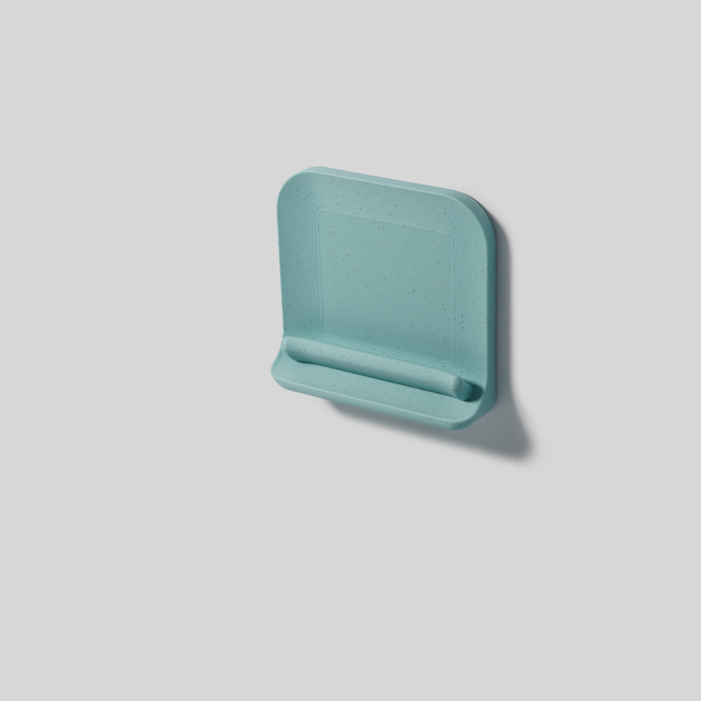 Teal wall mount double-sided tape on a light gray background