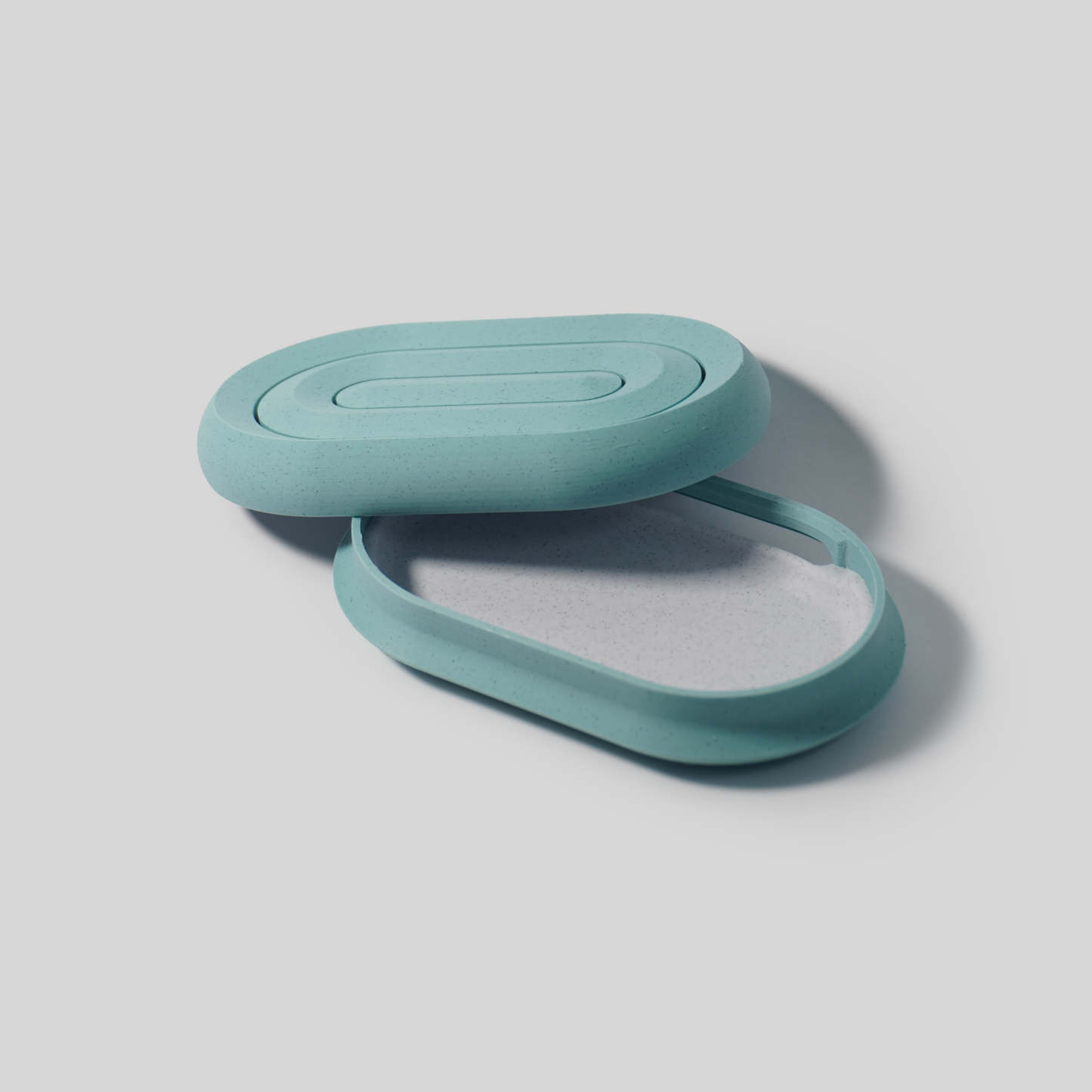 Two teal pla parts on a light gray background