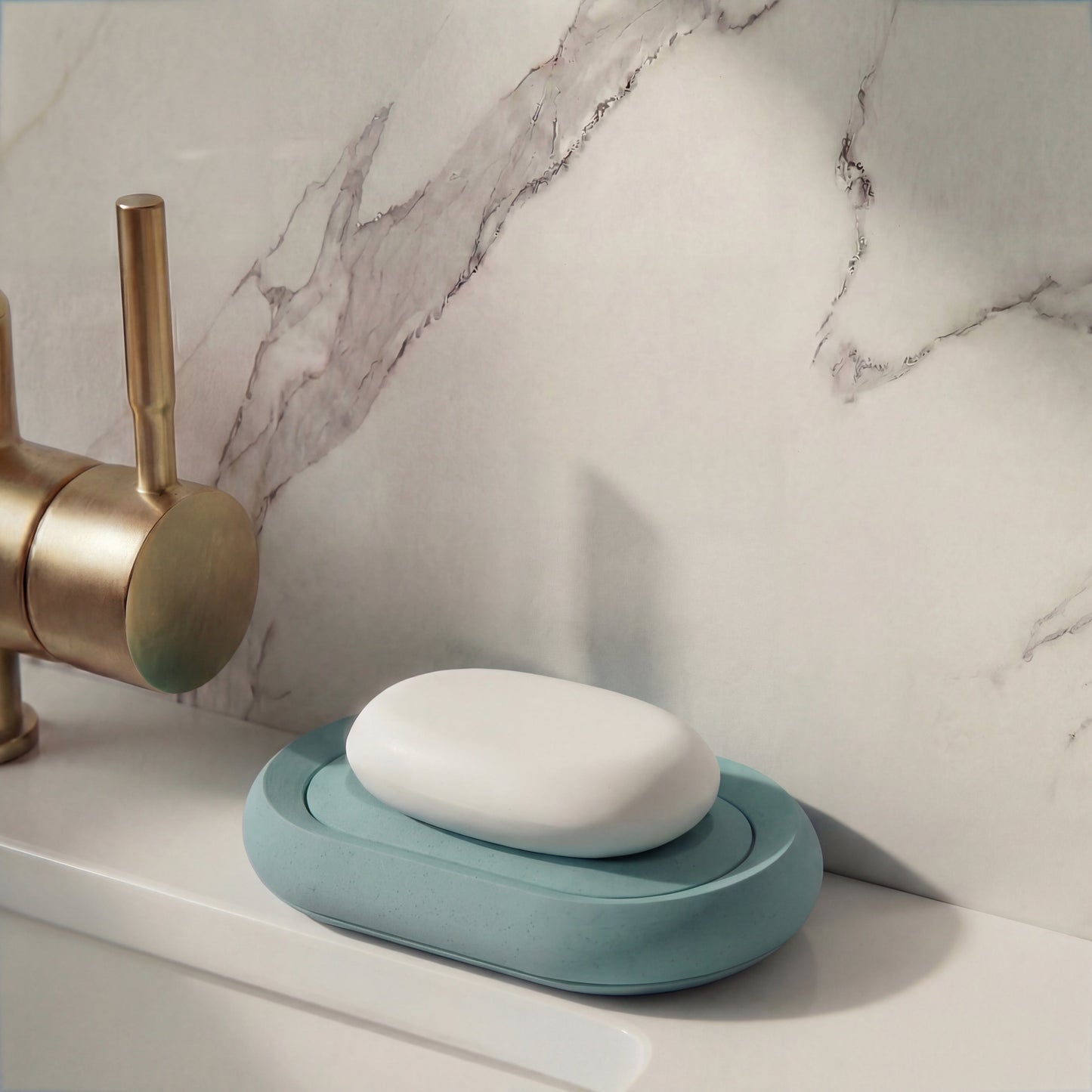 White soap on a blue soap dish with a marble wall and brass faucet in the background