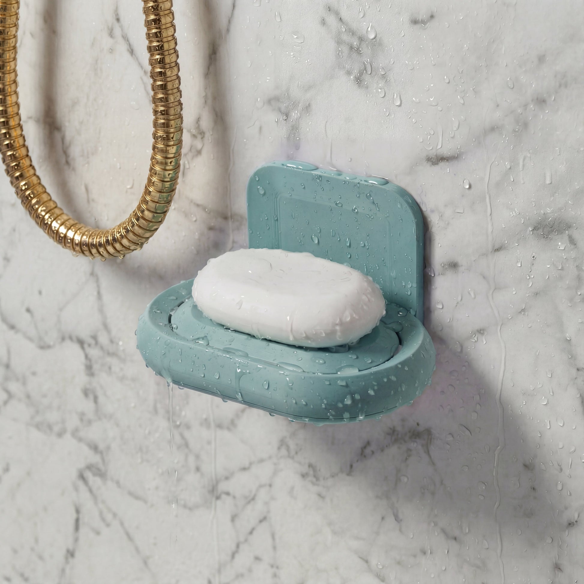 Teal soap dish with soap on a marble shower wall
