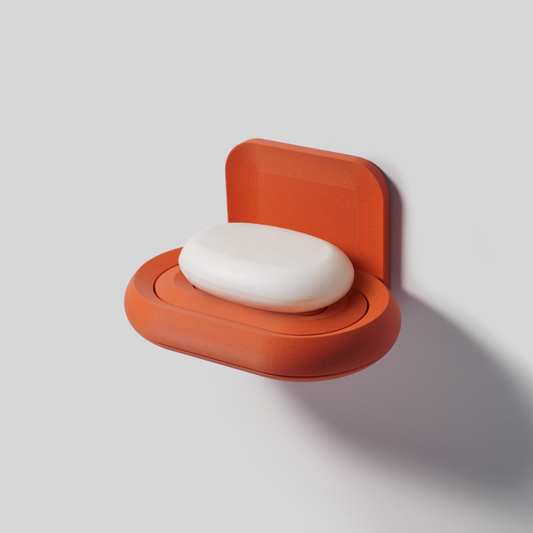 Wall-mounted SLOY soap holder in terracotta with soap bar attached