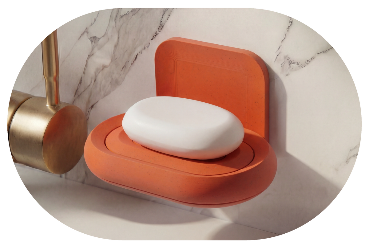 Terracotta soap holder with a bar of soap on a marble surface