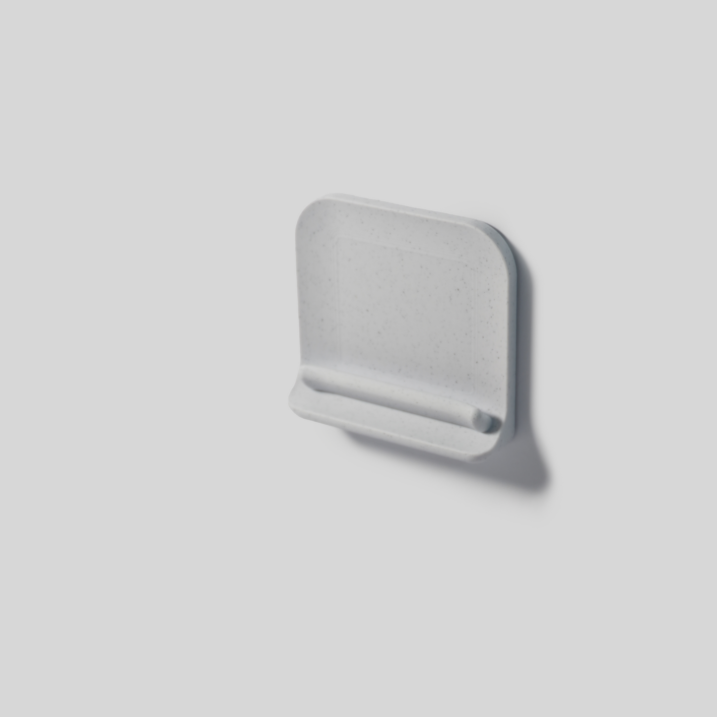 Graywall mount with adhisive on a light gray background