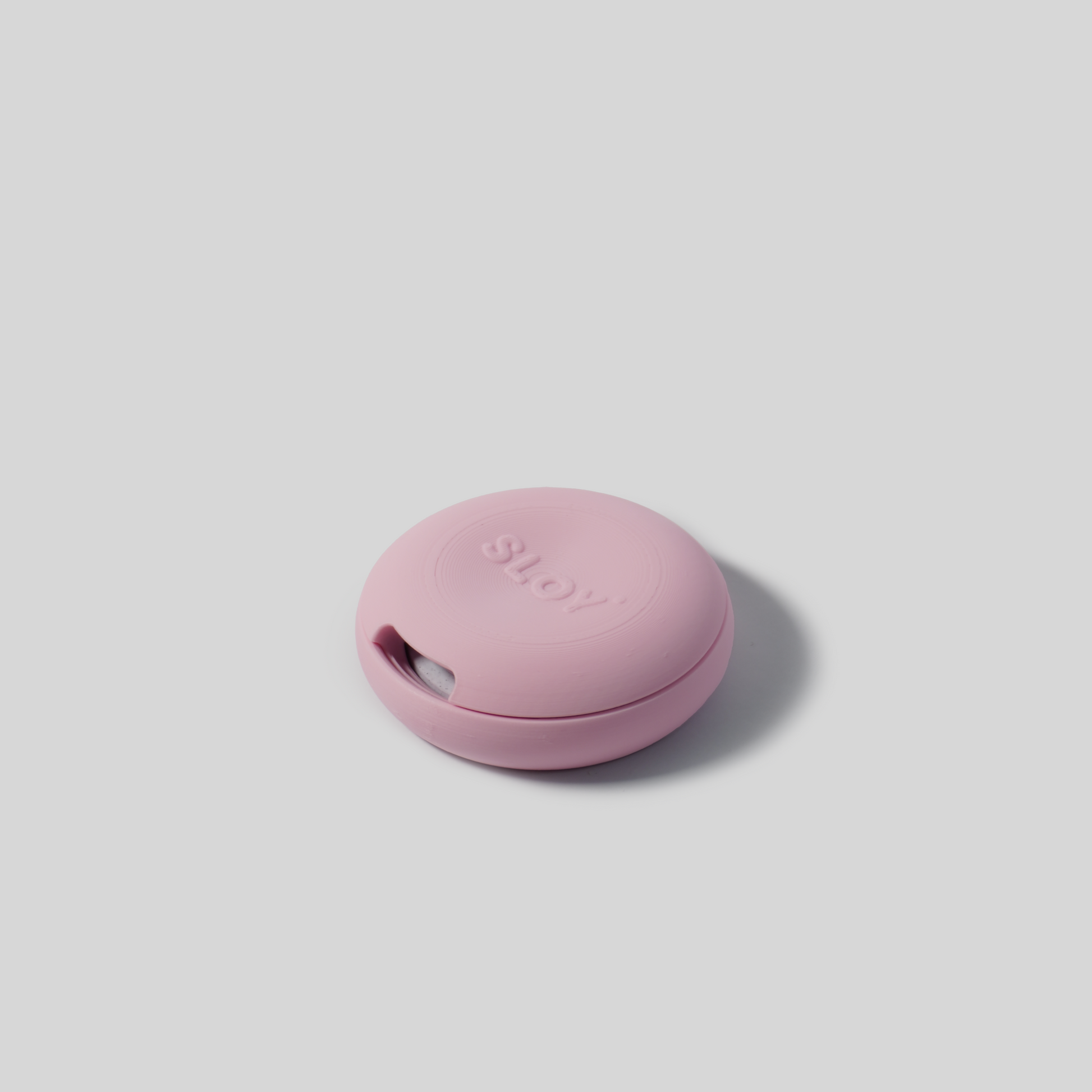 Pink soap holder with 'SLOY' branding on a light gray background