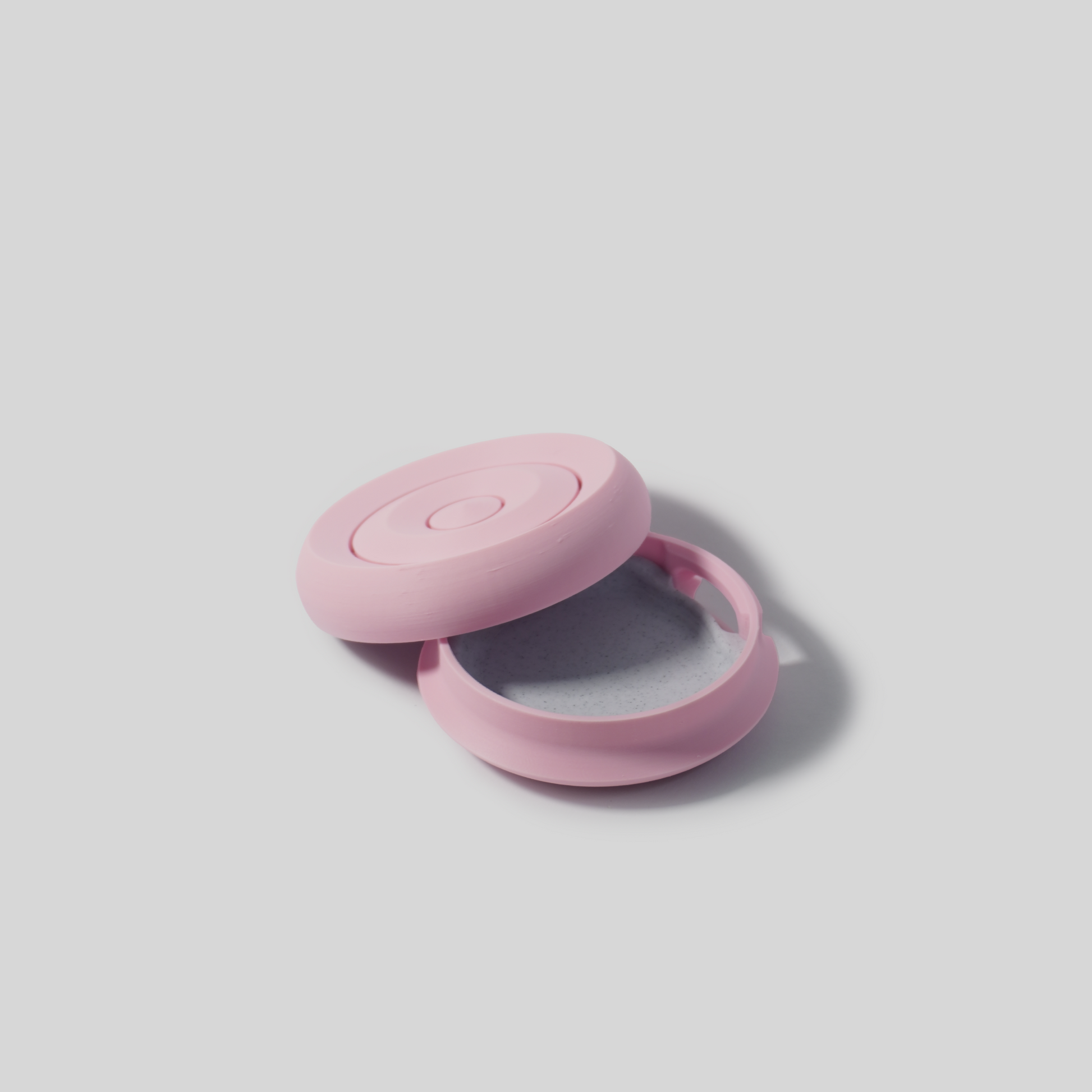 Pastel pink Mini Round Soap Holder on a light gray background open