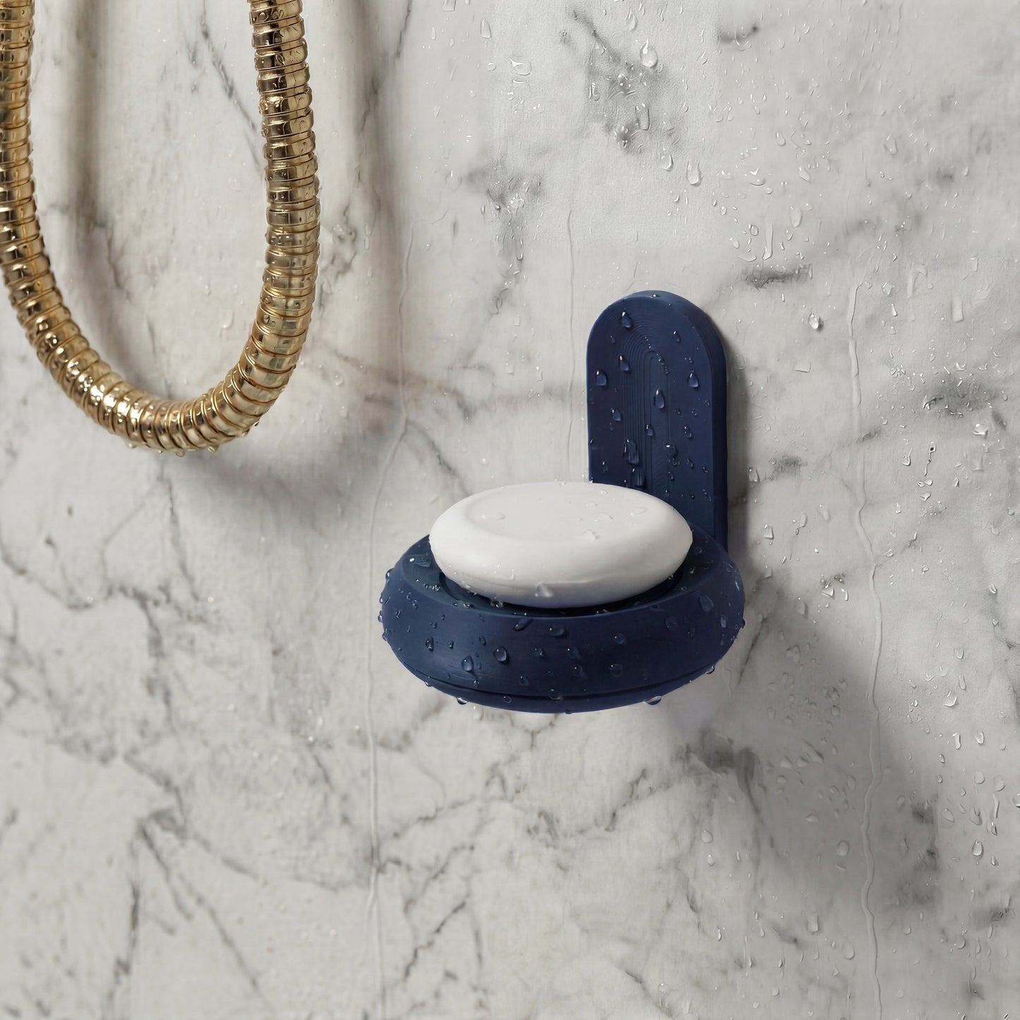 Blue soap holder with a white bar of soap on a marble bathroom wall shower.
