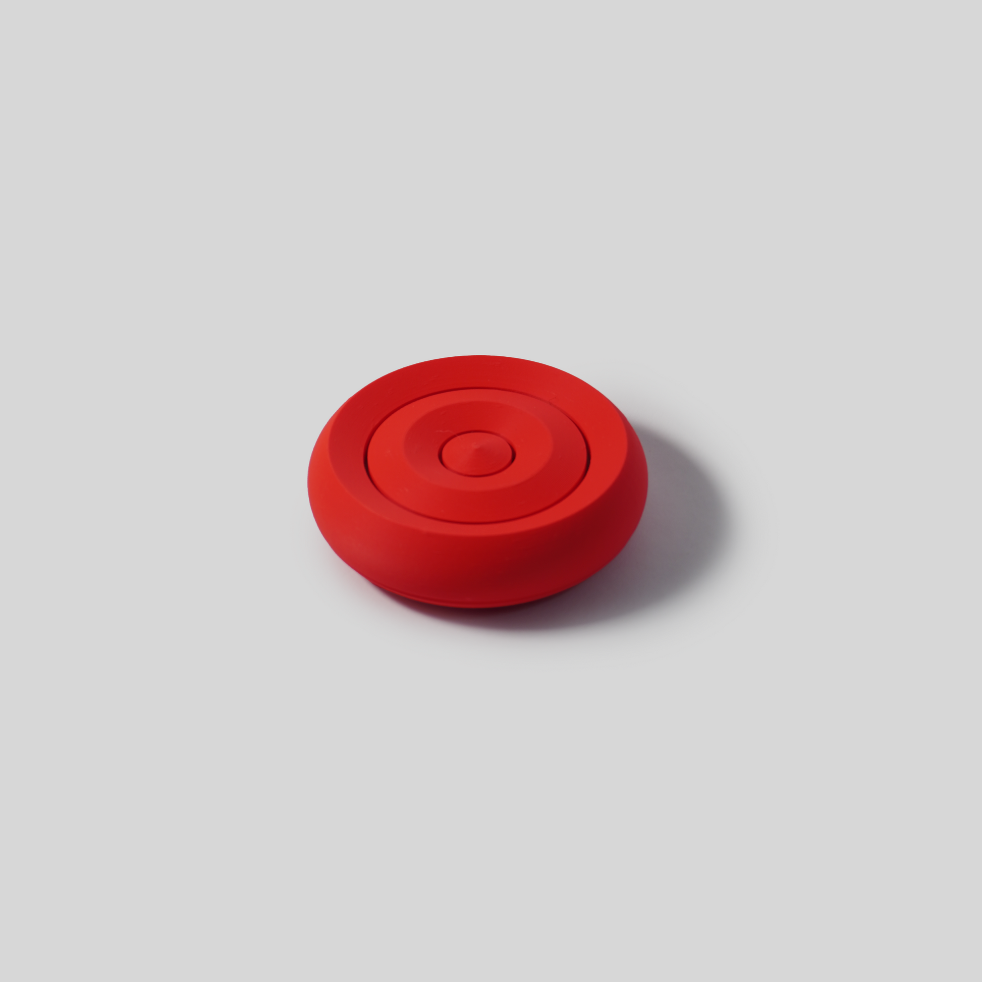 Red circular soap holder on a gray background