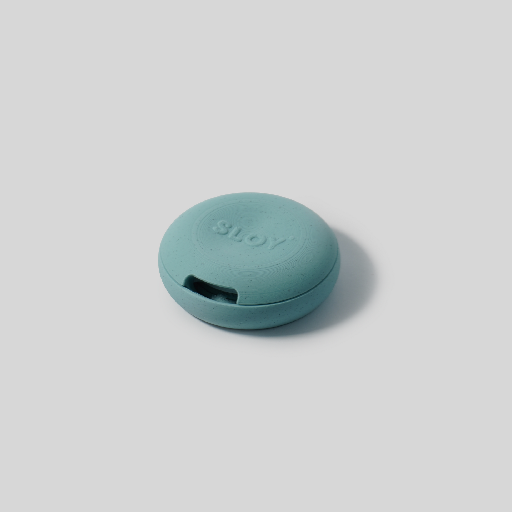 Teal PLA soap holder with 'SLOY' branding on a light gray background