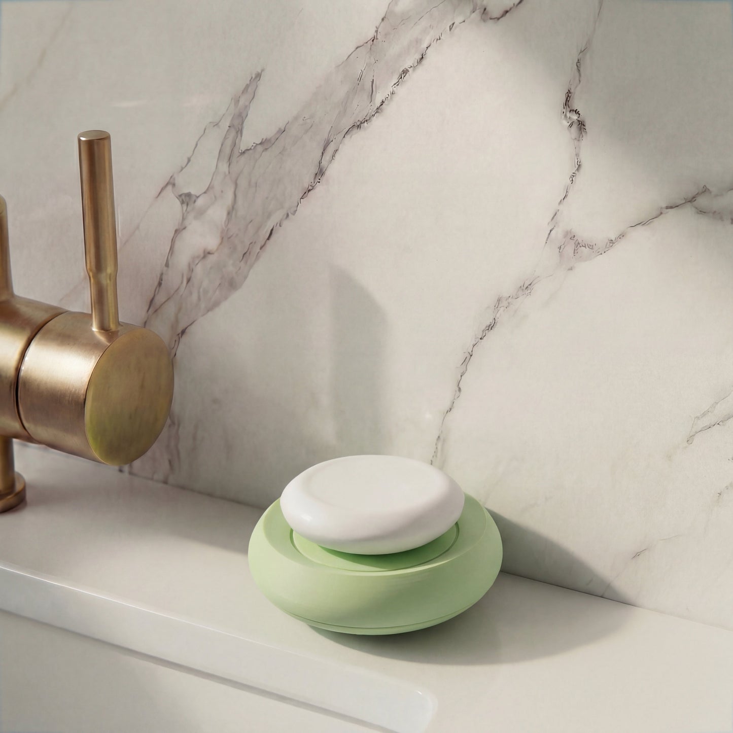 mint Green soap holder with soap on a marble bathroom counter with a brass faucet
